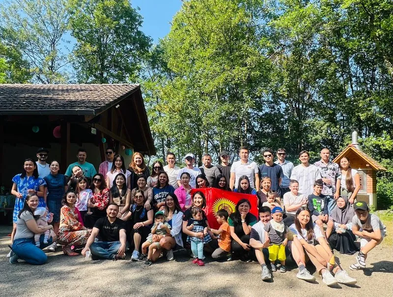 Großes Gruppenfoto beim Sommerfest mit kirgisischer Flagge